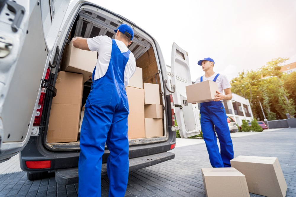 Two workers loading a van