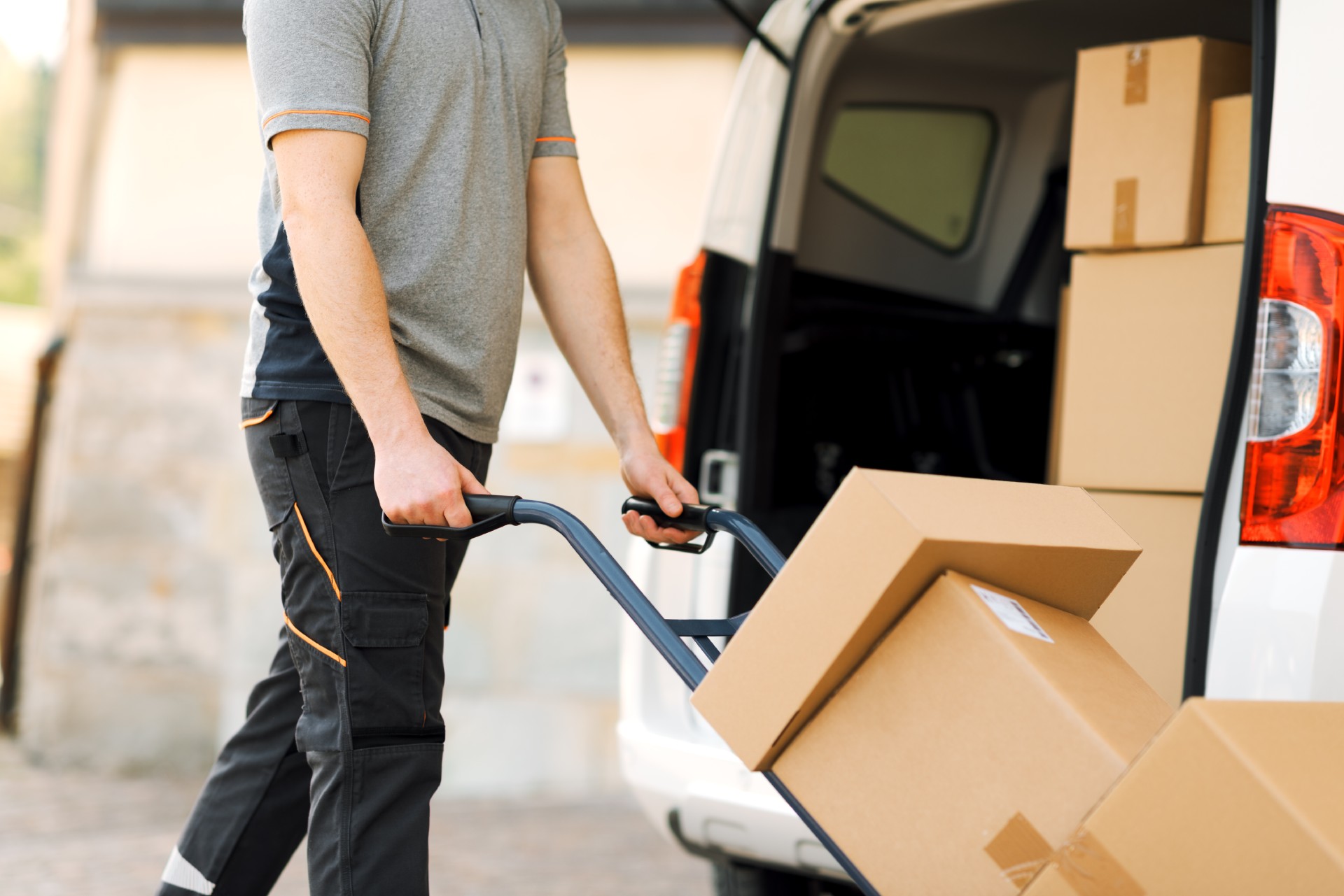 Person unloading boxes from van