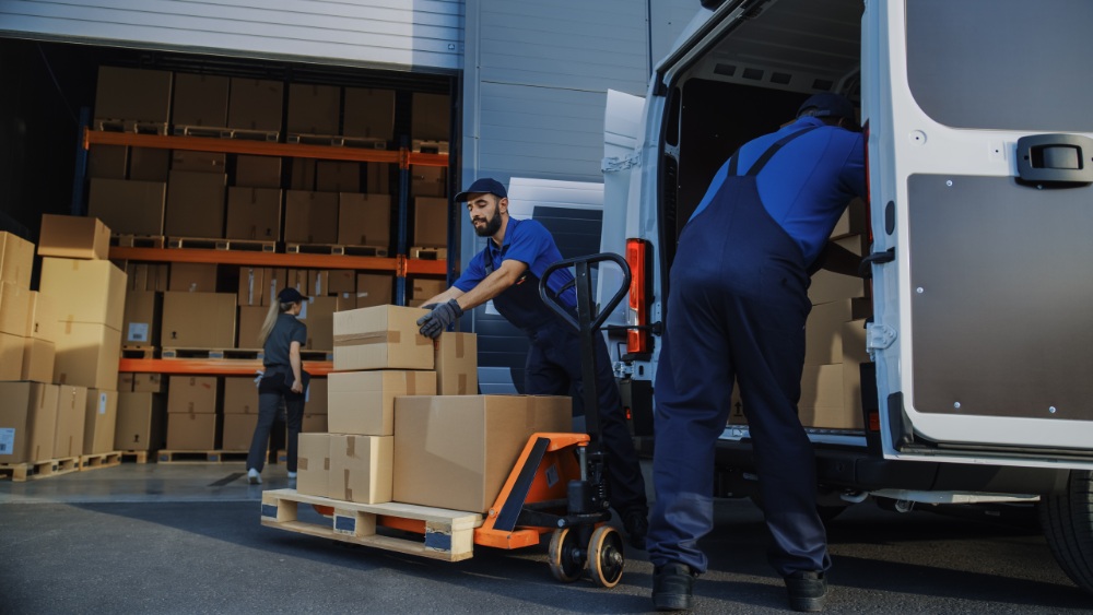 Workers loading boxes into van